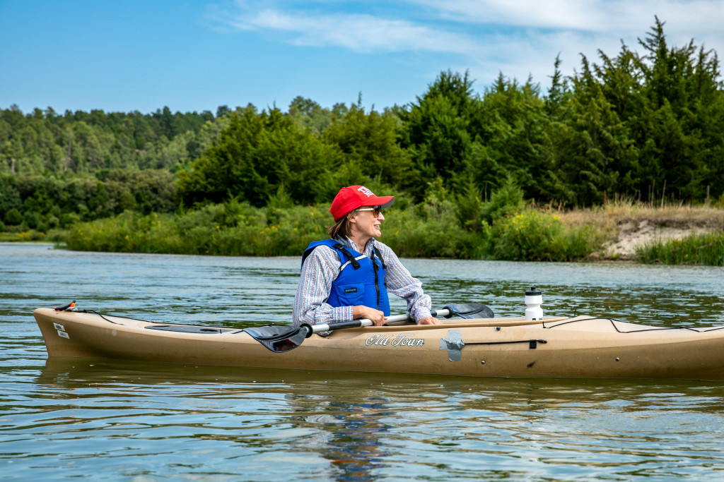 A woman kayaking on the river.