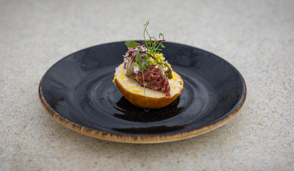 Bison tartare with pickled okra, cured egg yolk, garlic aioli and fry bread. 