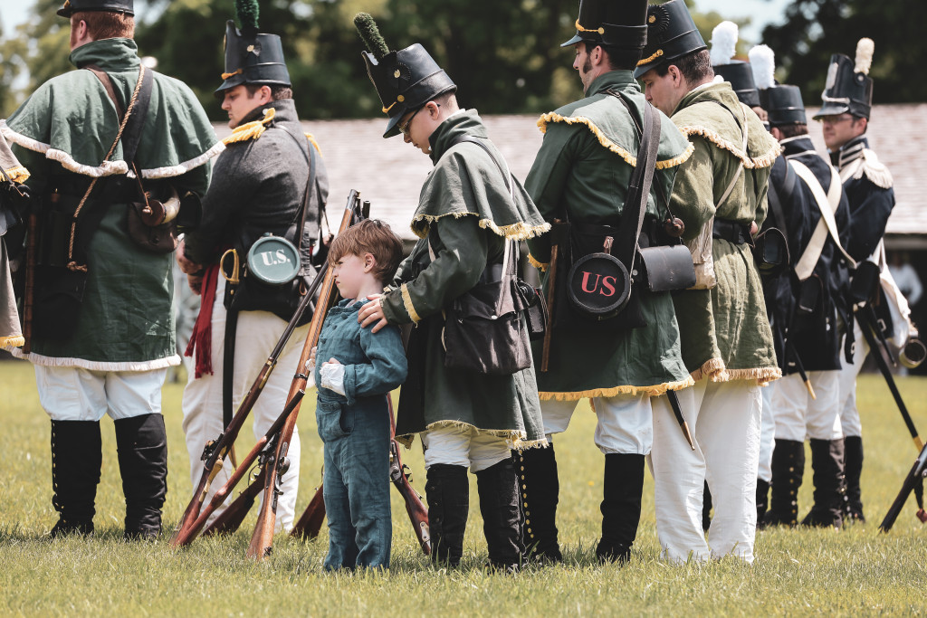 An older boy directing a a younger boy during roll call.