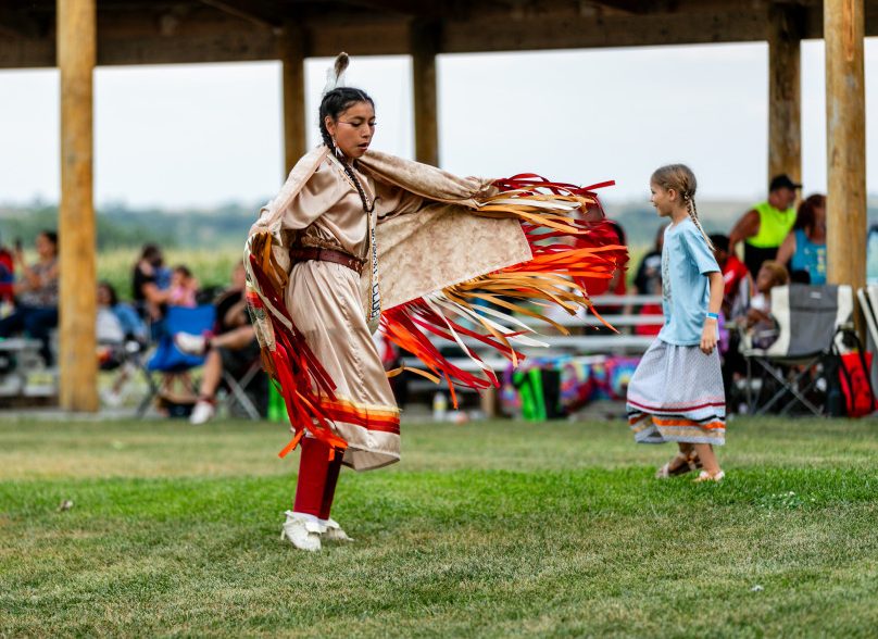 A woman dancing the fancy shawl dance.