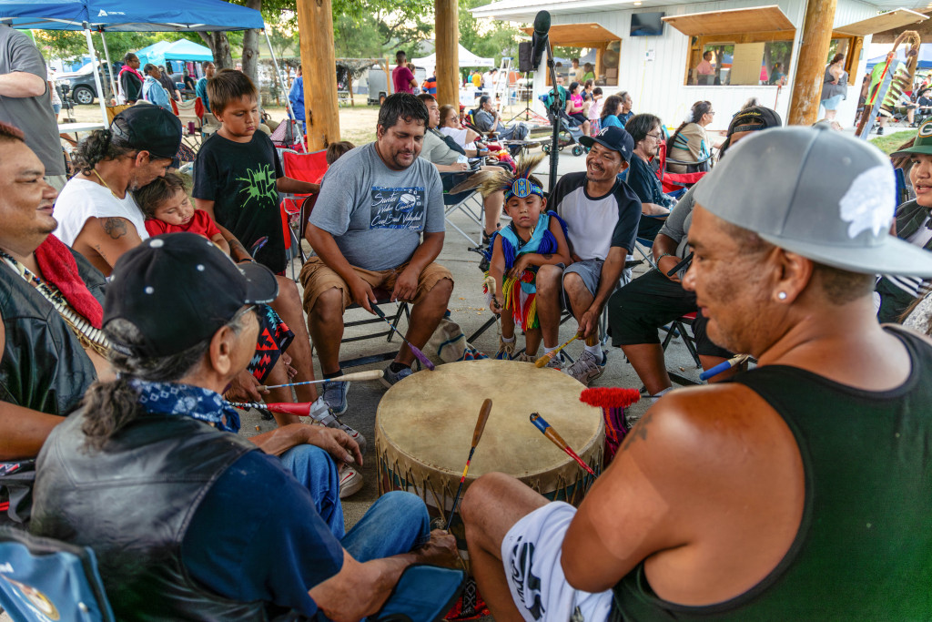 Men drumming in the middle of a powwow circle.