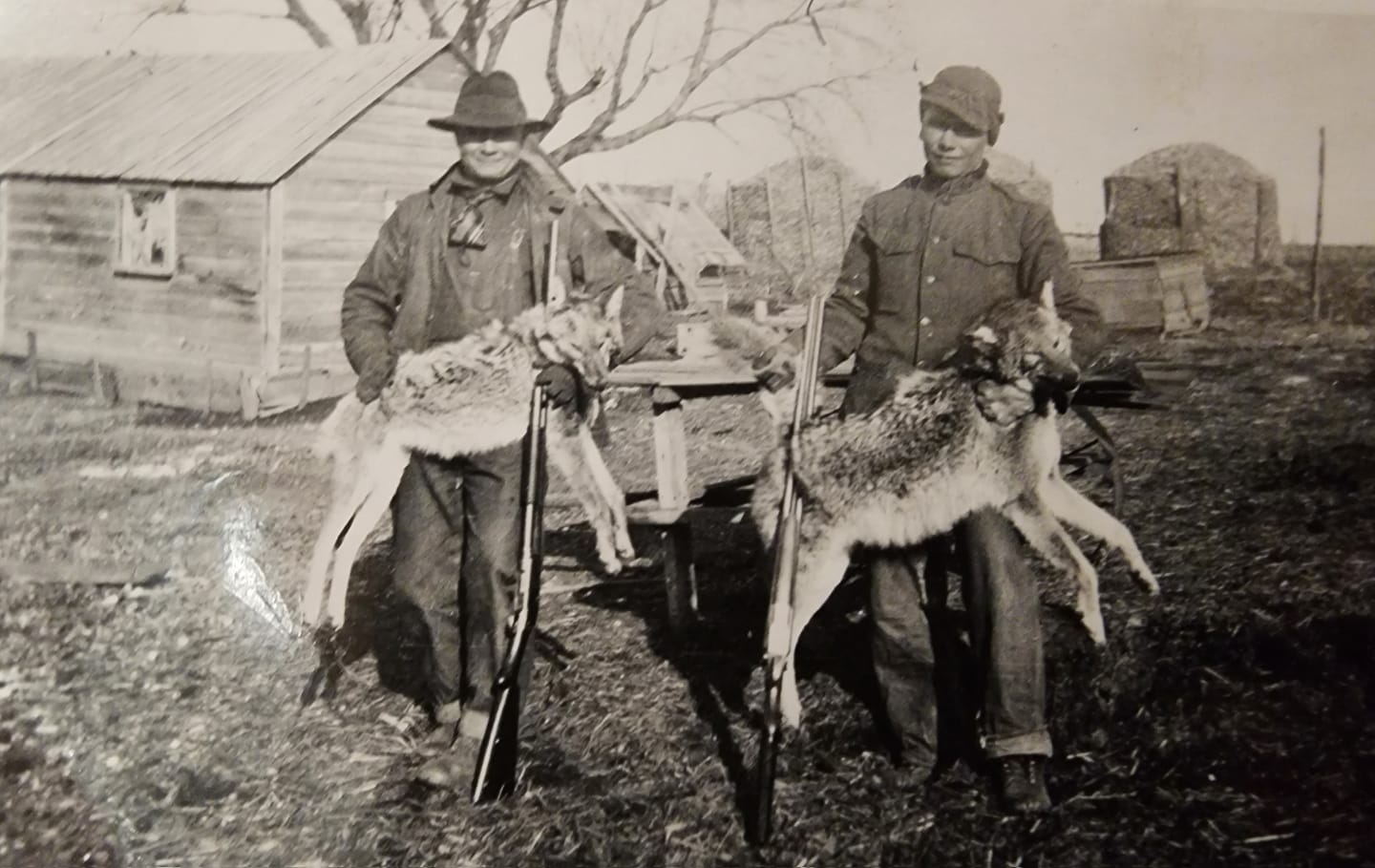 Vintage photo of two men with harvested coyotes in Nebraska.