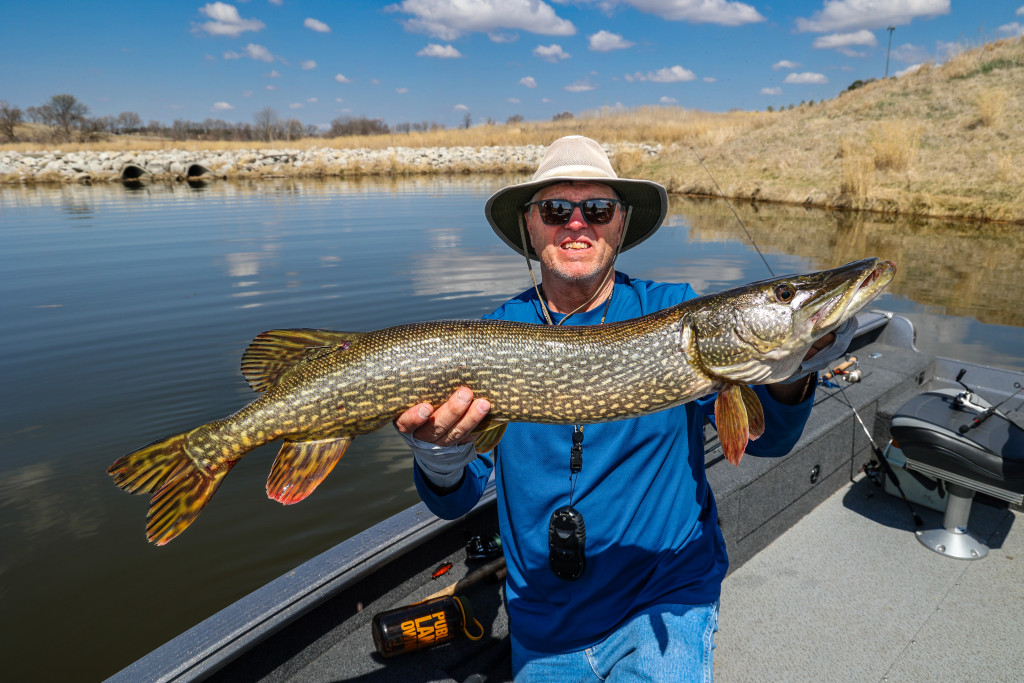 A man holding a northern pike.