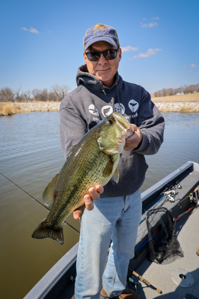 A man holding a largemouth bass.