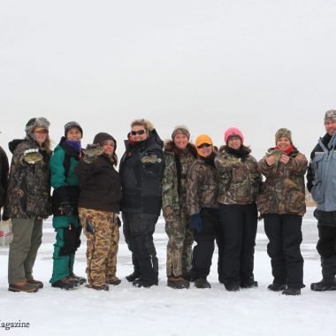 A group of people ice fishing.