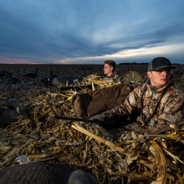 two high school kids in goose hunting in a cornfield