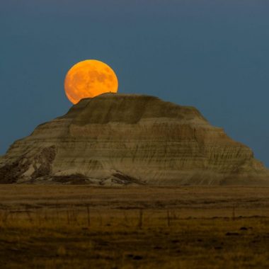 Full moon and Sugarloaf Butte