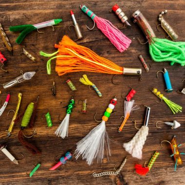 A collection of homemade fishing lures displayed on a table.