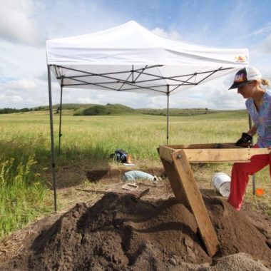 A University of Nebraska anthropology student Michelle Hayes attentively sifts through bucket-loads of dirt, hoping to spot artifacts.