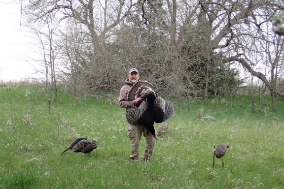 Daryl Bauer carrying a turkey.