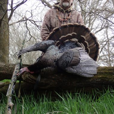 Daryl Bauer posing with a turkey.