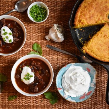 A top-down spread of homemade venison chili and cornbread.