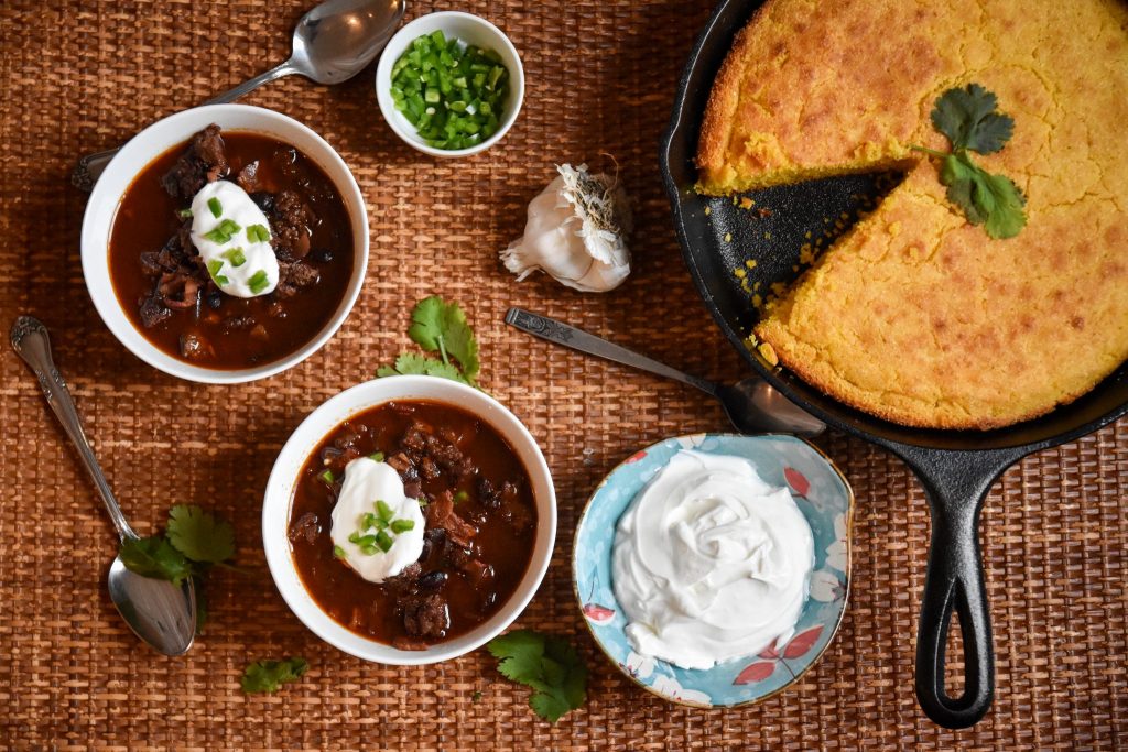 A top-down spread of homemade venison chili and cornbread.