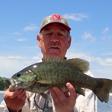 a man holding a smallmouth bass