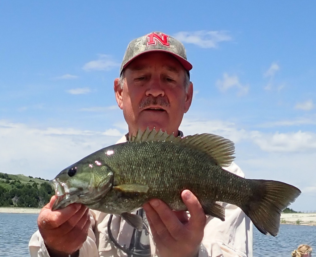 a man holding a smallmouth bass