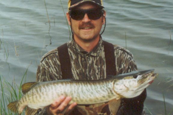 Daryl Bauer holding a tiger muskie.