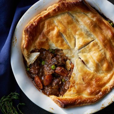 Venison and vegetable-filled pot pie with puff pastry.