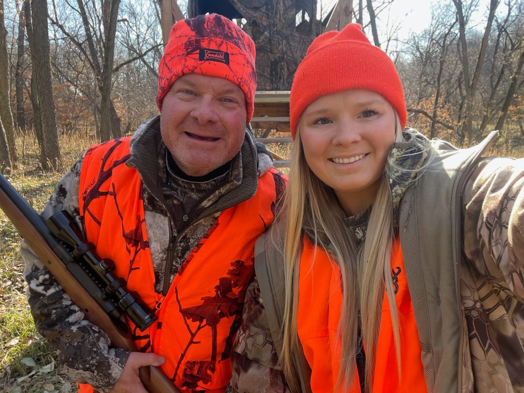 A man and his daughter deer hunting in a forest in Nebraska in November.