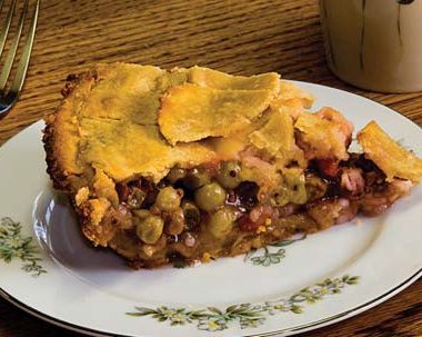 A close-up of a piece of gooseberry pie on a plate.