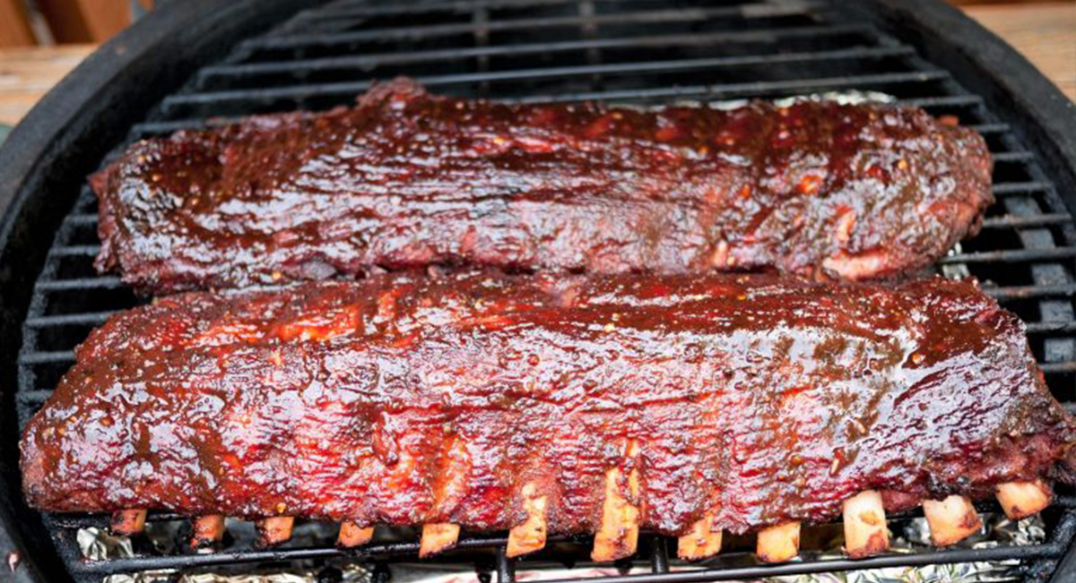 Barbecued ribs on a grill.