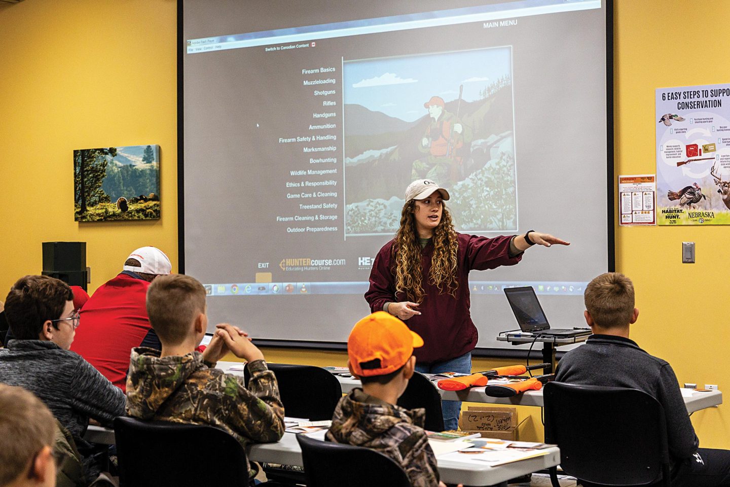 A female hunter education instructor teaching a hunt safe session class.