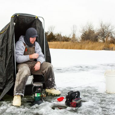 A man ice fishing.