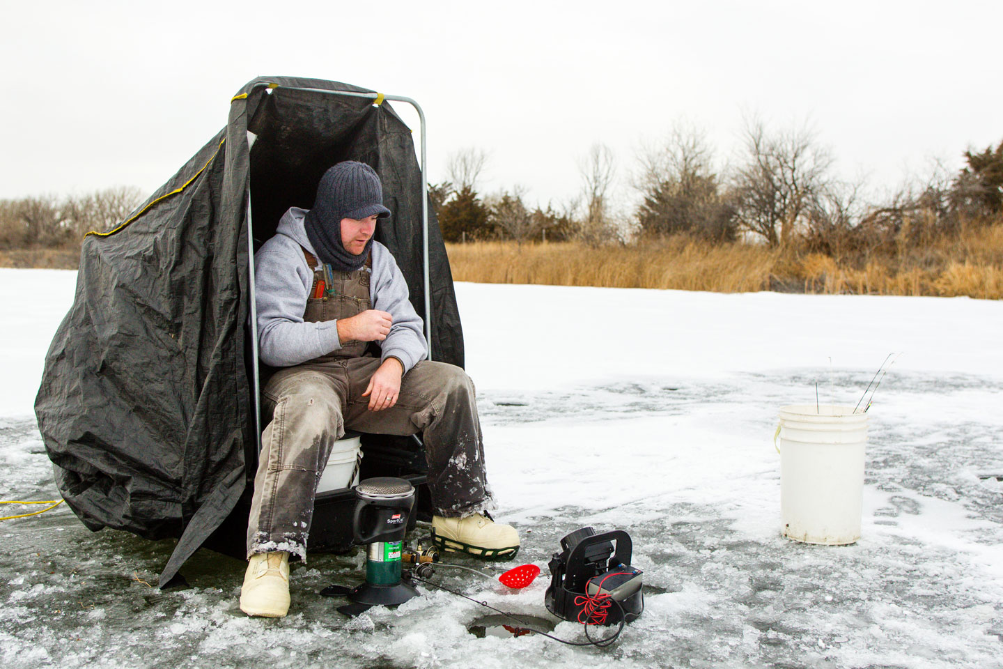 A man ice fishing.