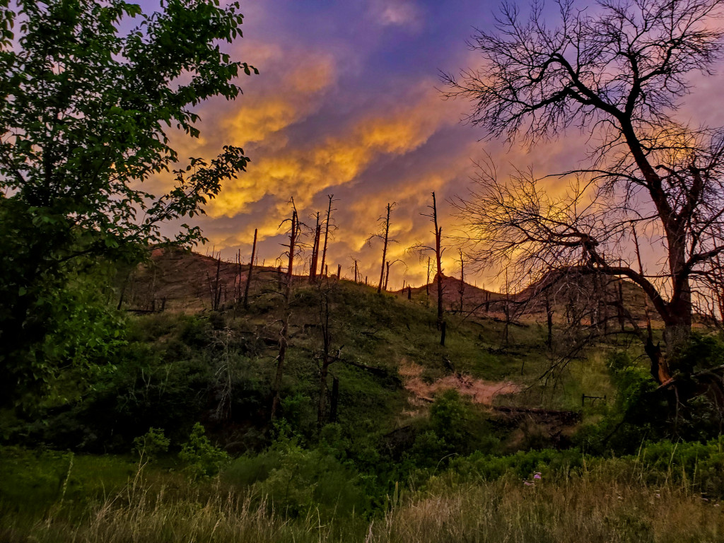 Clouds glow above East Ash Creek Canyon at dusk in the Pine Ridge.