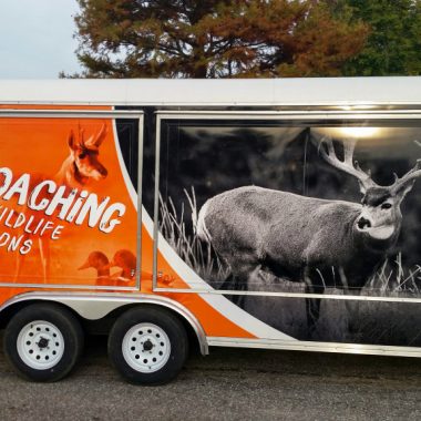 a picture of a trailer with 'Stop Poaching: Report Wildlife Violations" on it